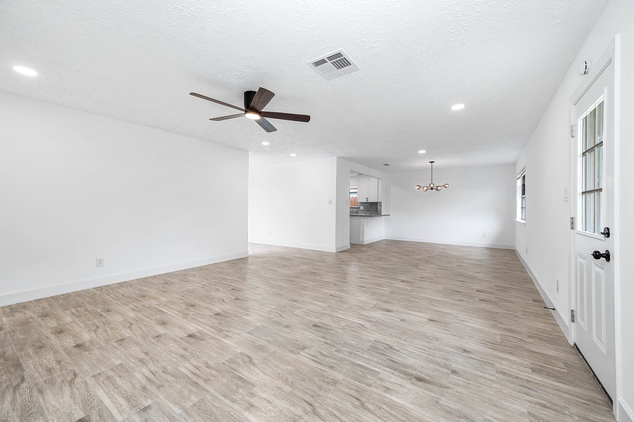 10402 Rancho Bernardo Lane Sugar Land, TX 77498 - Photo 12 of 30 a view of empty room with wooden floor and ceiling fan