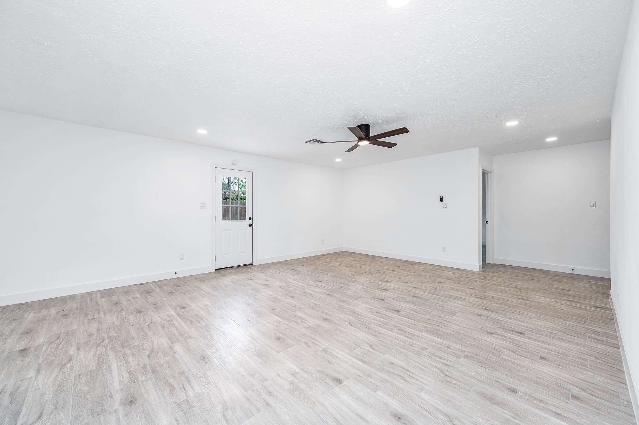 10402 Rancho Bernardo Lane Sugar Land, TX 77498 - Photo 13 of 30 an empty room with wooden floor and windows