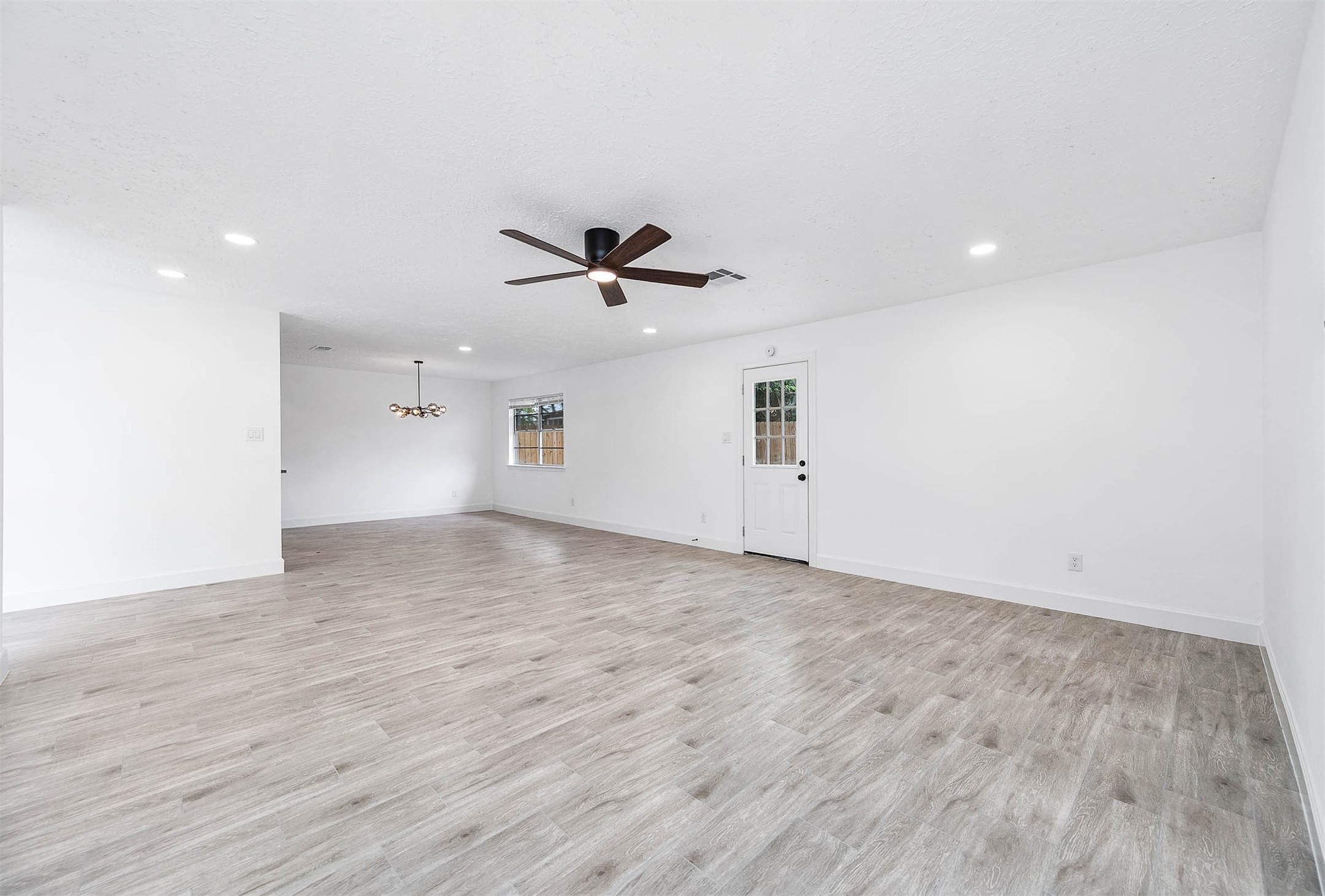 10402 Rancho Bernardo Lane Sugar Land, TX 77498 - Photo 14 of 30 a view of empty room with wooden floor and ceiling fan