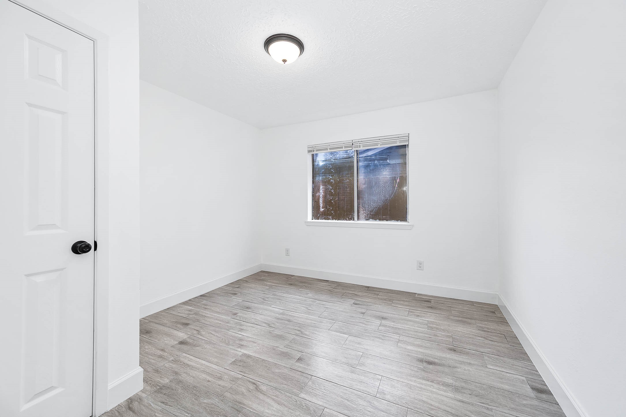 10402 Rancho Bernardo Lane Sugar Land, TX 77498 - Photo 18 of 30 a view of an empty room with wooden floor and a window