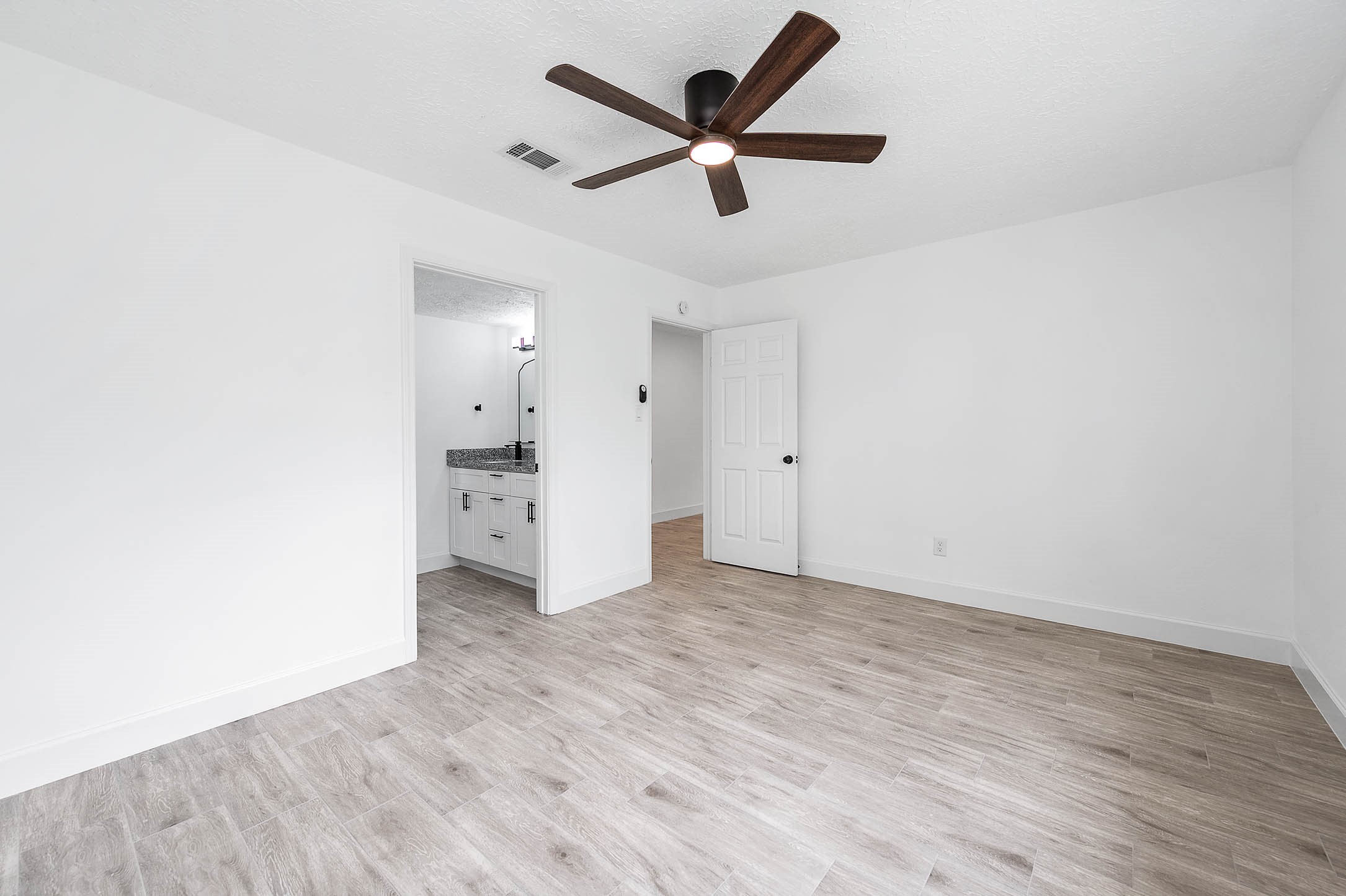 10402 Rancho Bernardo Lane Sugar Land, TX 77498 - Photo 20 of 30 a view of an empty room and wooden floor