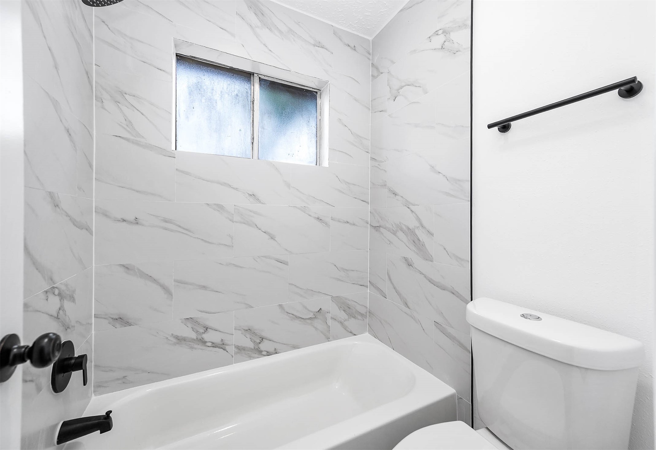 10402 Rancho Bernardo Lane Sugar Land, TX 77498 - Photo 22 of 30 a bathroom with a toilet and a bathtub
