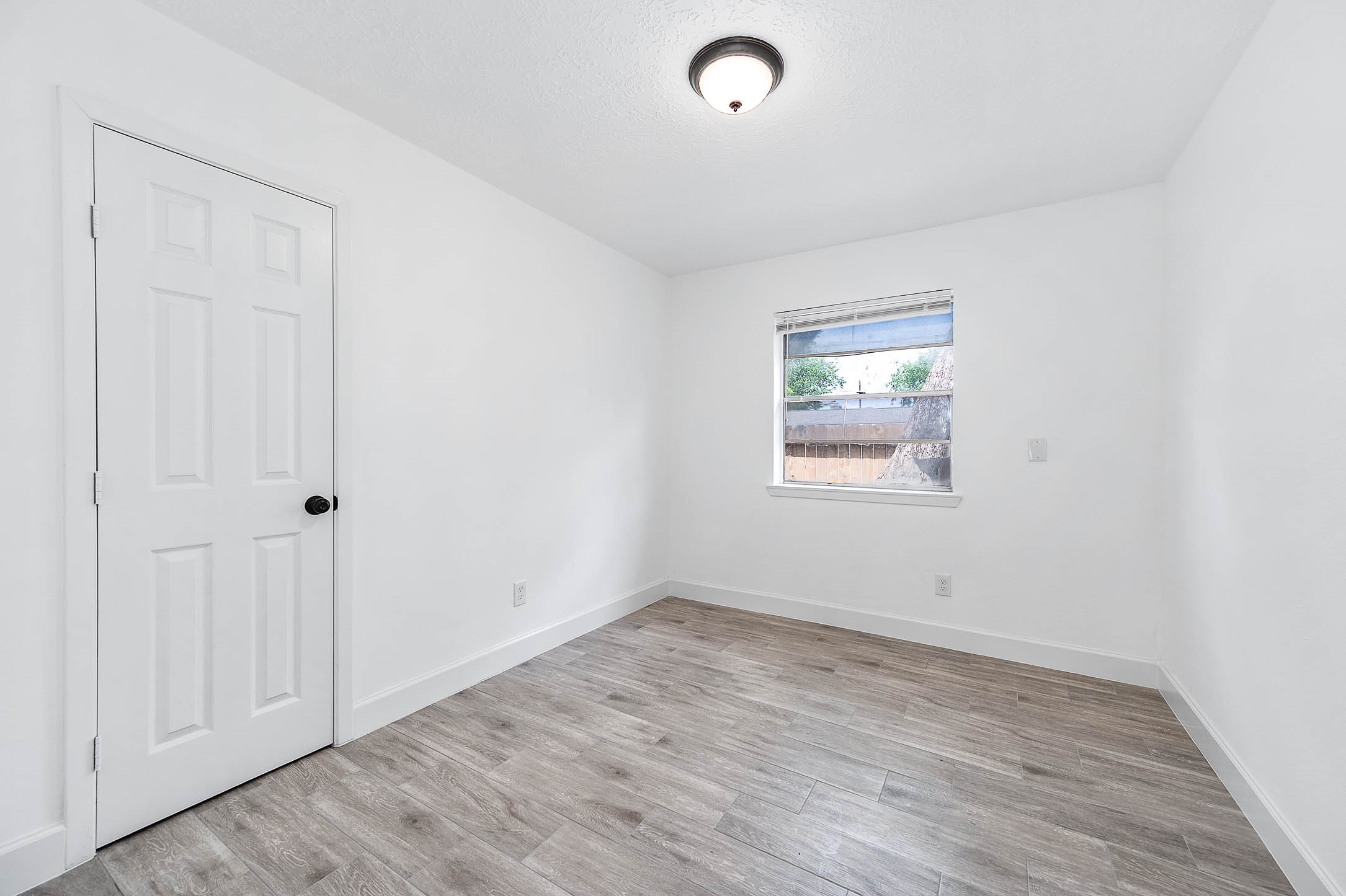 10402 Rancho Bernardo Lane Sugar Land, TX 77498 - Photo 24 of 30 an empty room with wooden floor and windows