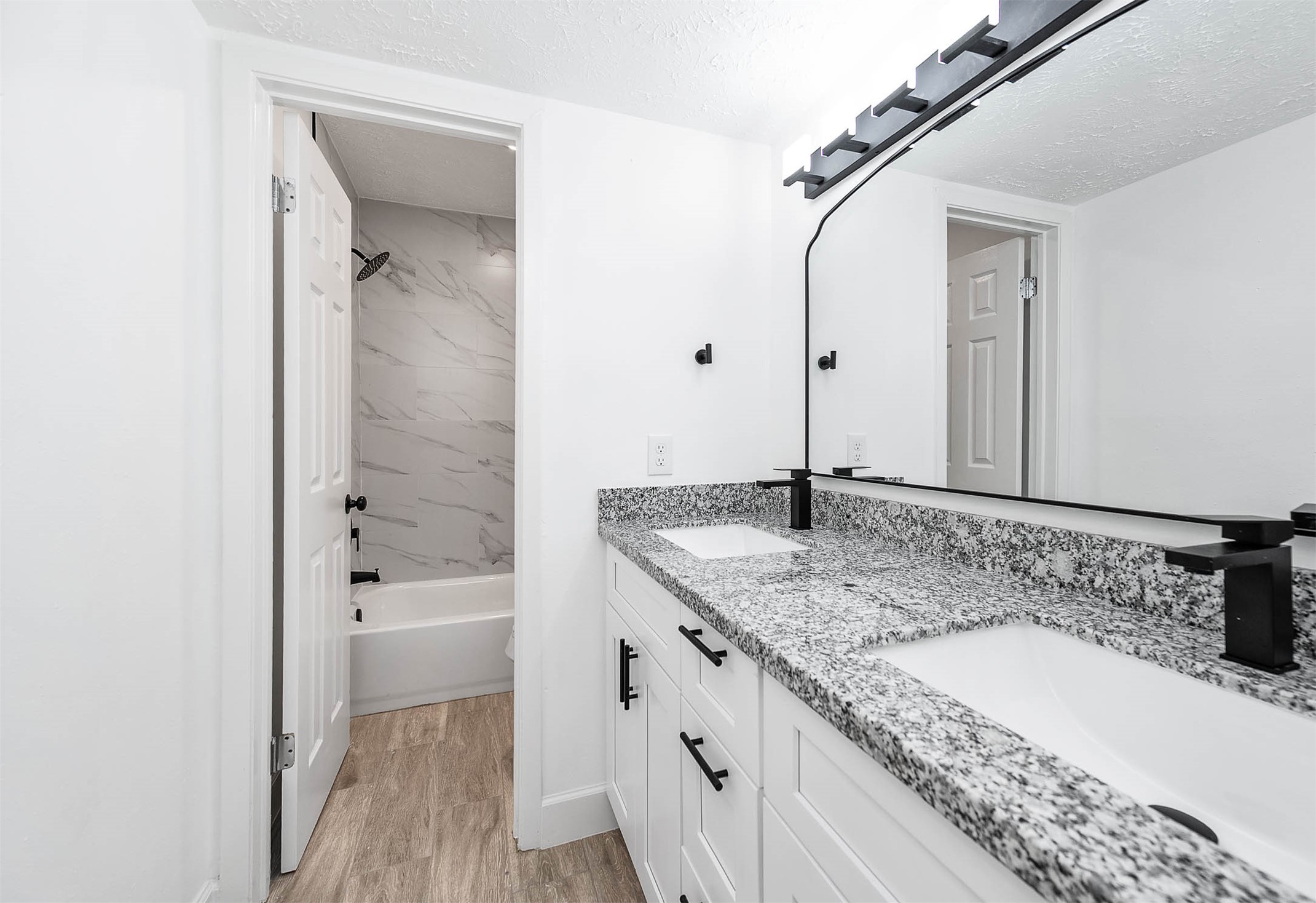 10402 Rancho Bernardo Lane Sugar Land, TX 77498 - Photo 25 of 30 a bathroom with a granite countertop sink a mirror and shower