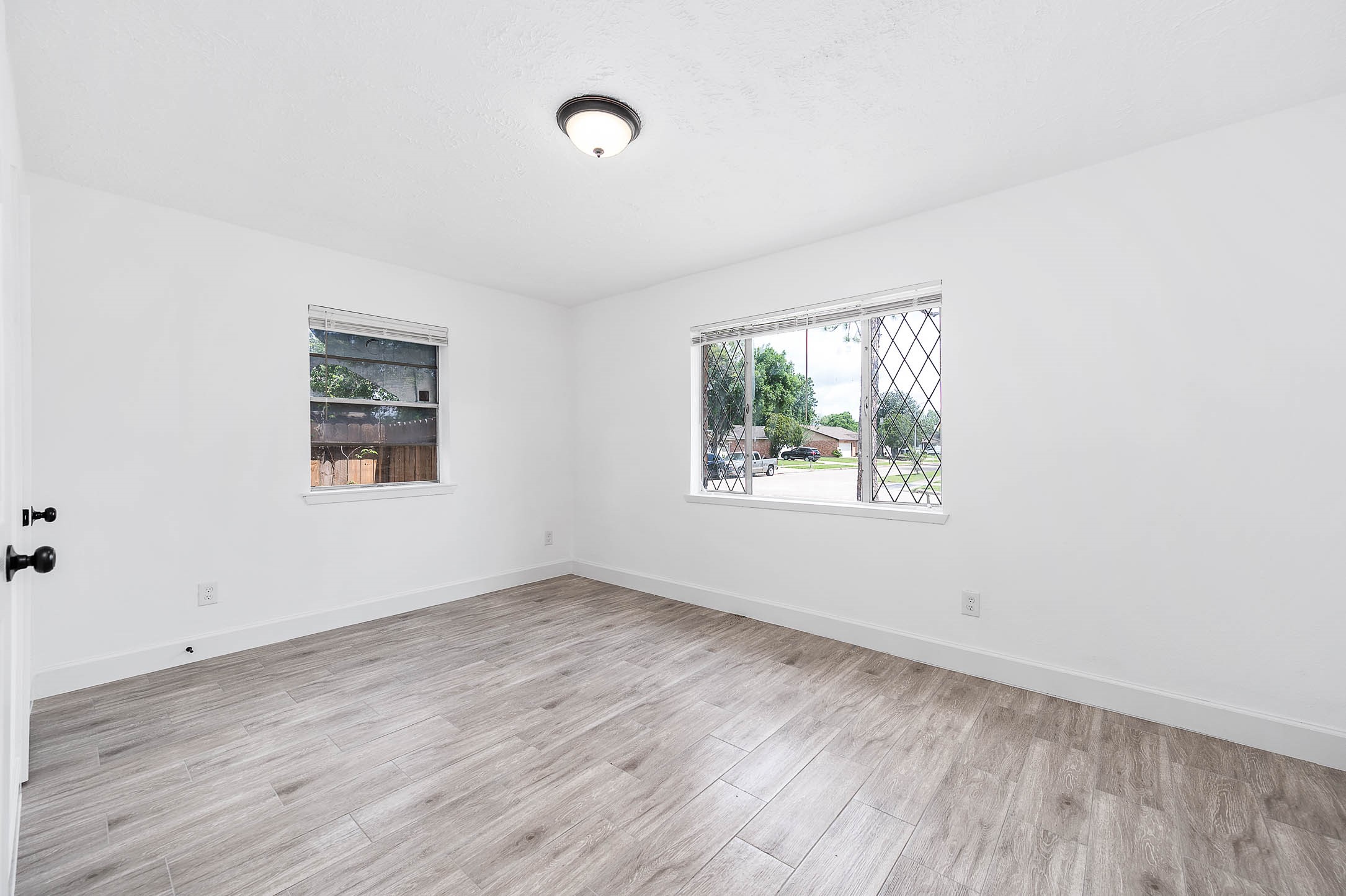 10402 Rancho Bernardo Lane Sugar Land, TX 77498 - Photo 26 of 30 an empty room with wooden floor and windows