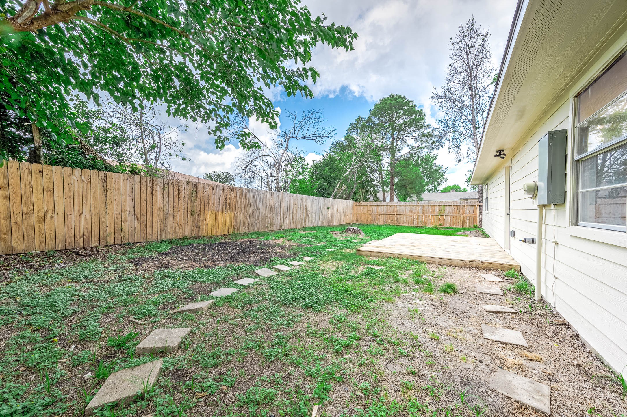 10402 Rancho Bernardo Lane Sugar Land, TX 77498 - Photo 27 of 30 a view of backyard with tree