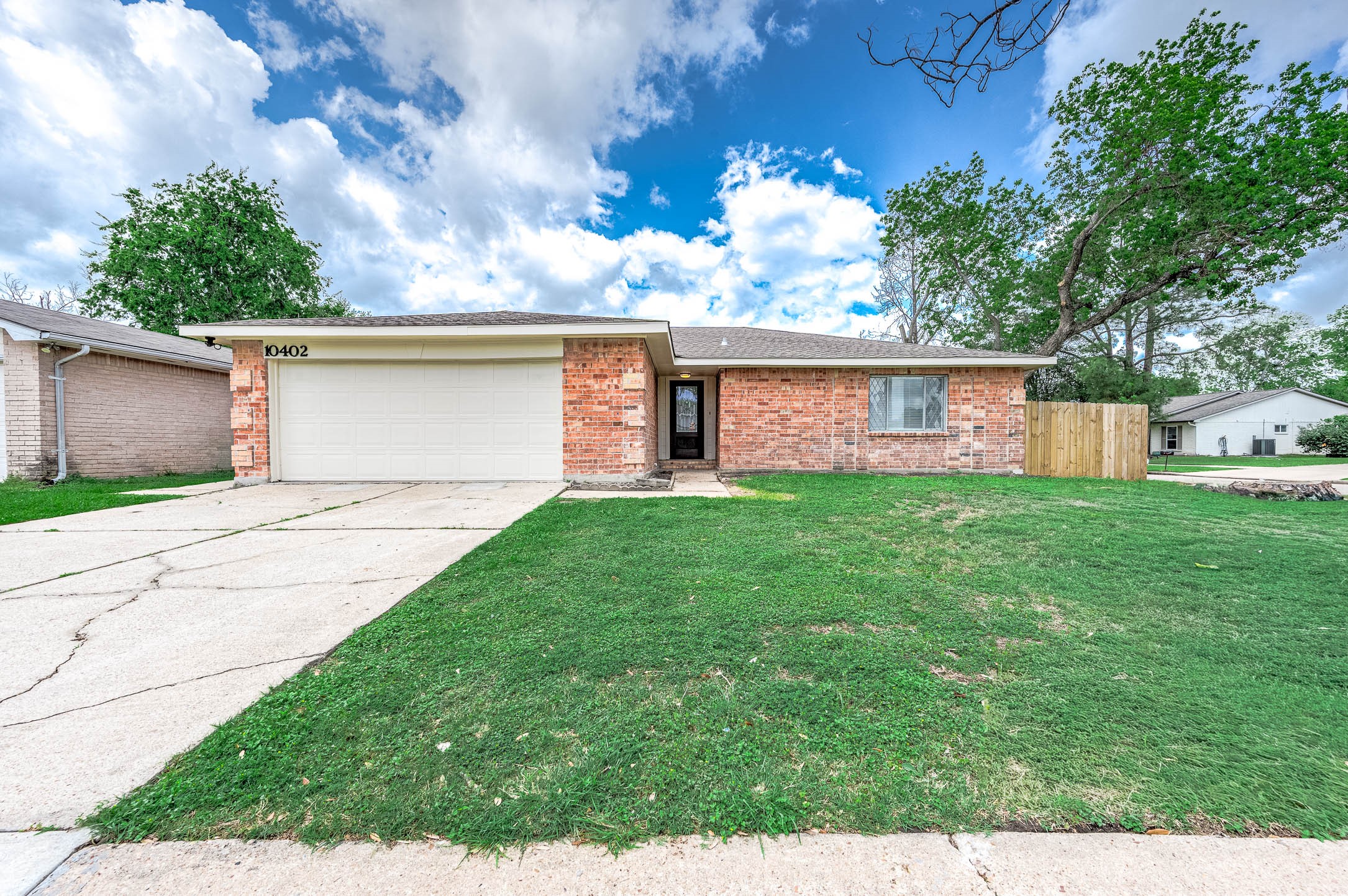 10402 Rancho Bernardo Lane Sugar Land, TX 77498 - Photo 3 of 30 a front view of a house with a garden and yard