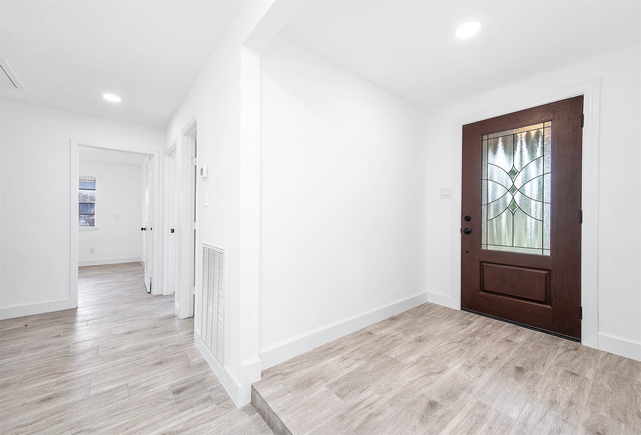 10402 Rancho Bernardo Lane Sugar Land, TX 77498 - Photo 5 of 30 an empty room with wooden floor and windows