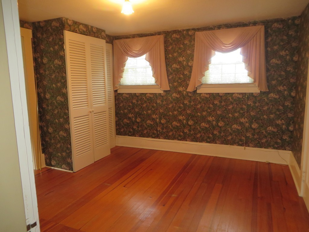194 Turnpike Road Montague, MA 01351 - Photo 20 of 30 an empty room with wooden floor and windows