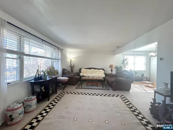 a room with painting on the wall and a chandelier