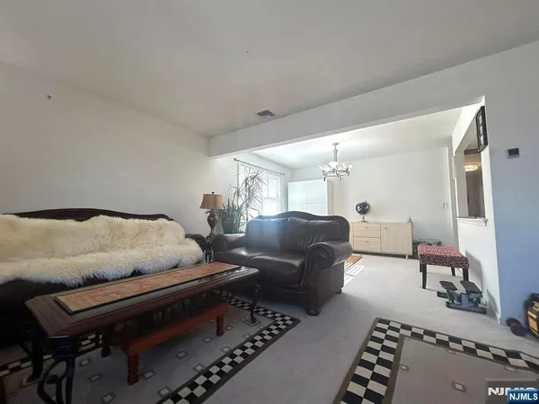 a kitchen with a refrigerator a stove and a dining table