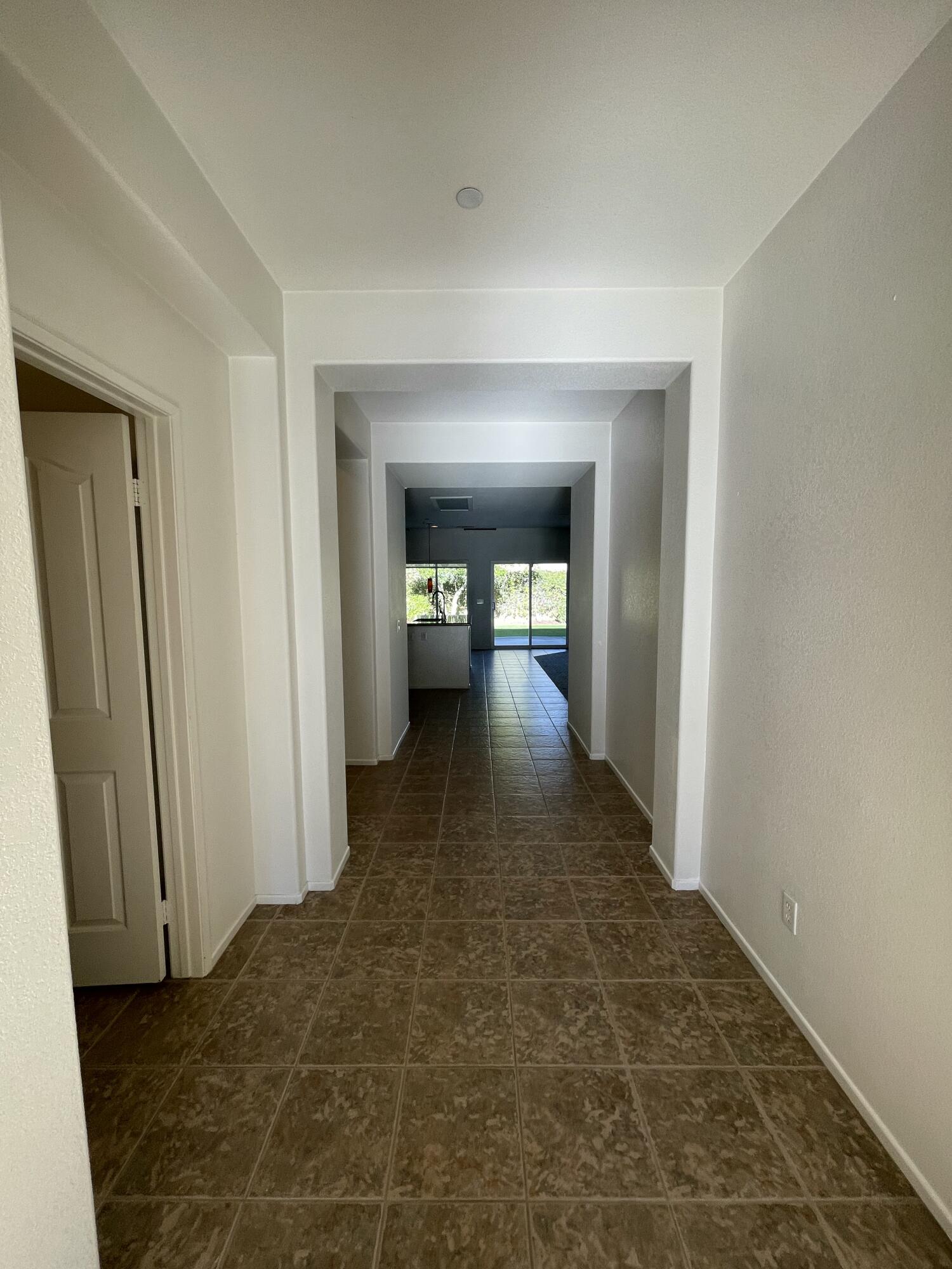 1122 Oro Ridge Palm Springs, CA 92262 - Photo 14 of 33 a view of a hallway with wooden floor and a bathroom