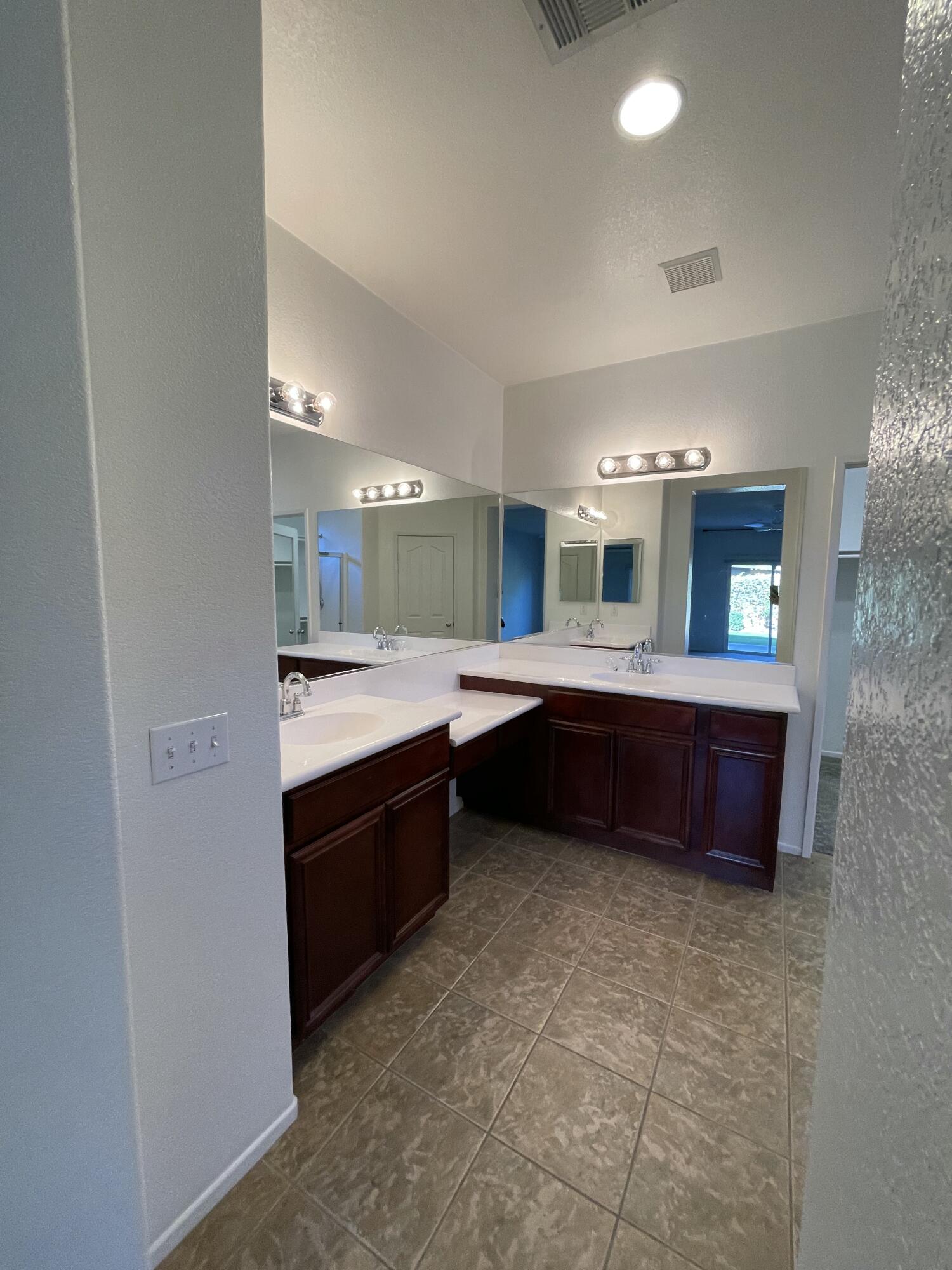 1122 Oro Ridge Palm Springs, CA 92262 - Photo 19 of 33 a large bathroom with a double vanity sink and a mirror