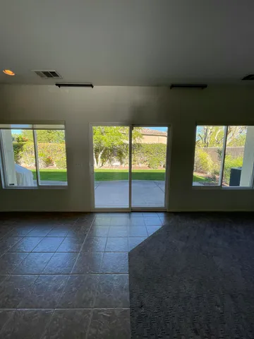 a view of a house with backyard sitting area and garden