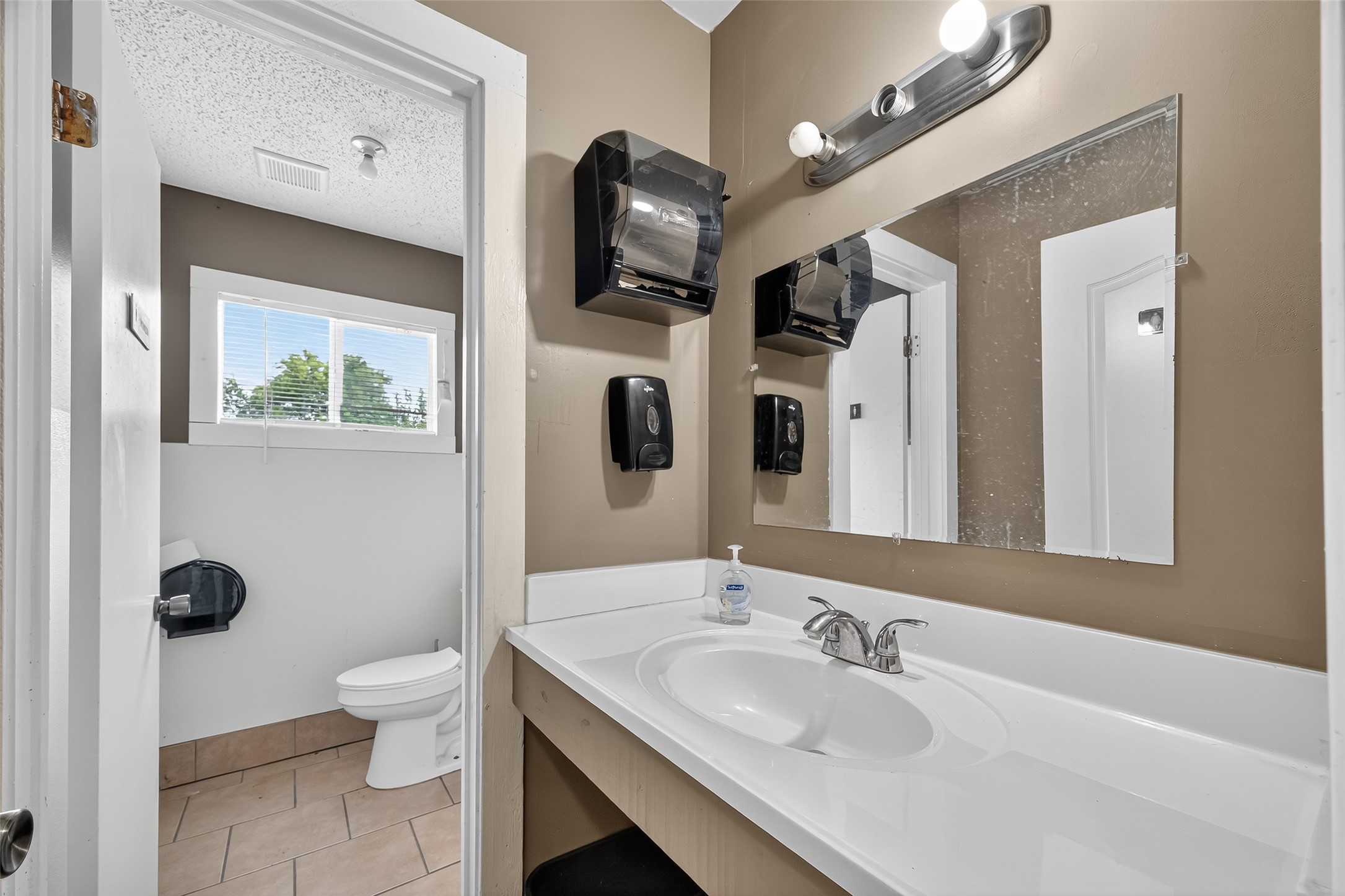 816 Barbara Mae Street Houston, TX 77015 - Photo 9 of 18 a bathroom with a sink a toilet and a mirror