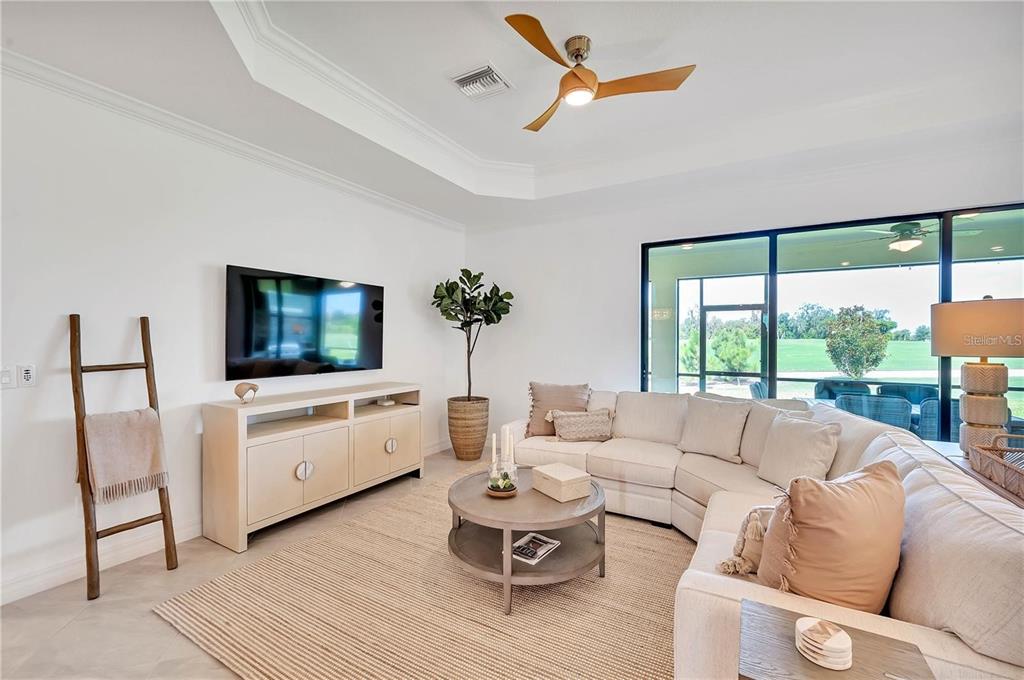 5822 Brandon Run Bradenton, FL 34211 - Photo 11 of 34 a living room with furniture a flat screen tv and a large window