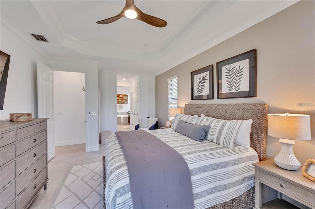 5822 Brandon Run Bradenton, FL 34211 - Photo 16 of 34 a bedroom with a bed and a chandelier