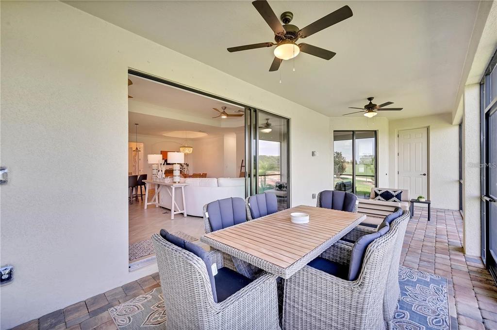5822 Brandon Run Bradenton, FL 34211 - Photo 20 of 34 a dining room with furniture a rug and a chandelier