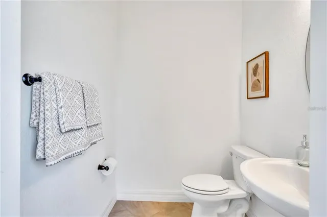 a spacious bedroom with a bed and a chandelier