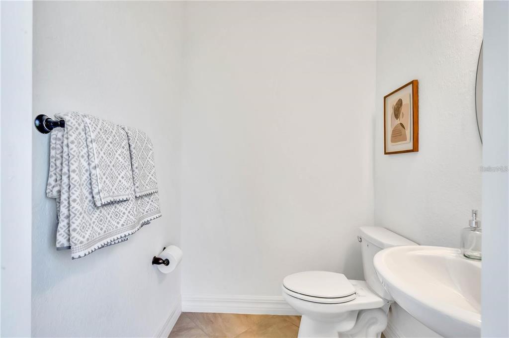 5822 Brandon Run Bradenton, FL 34211 - Photo 21 of 34 a white toilet sitting next to a bathroom sink