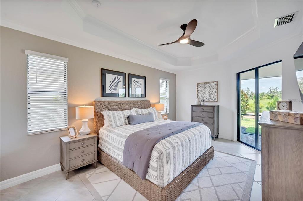 5822 Brandon Run Bradenton, FL 34211 - Photo 22 of 34 a spacious bedroom with a bed and a chandelier