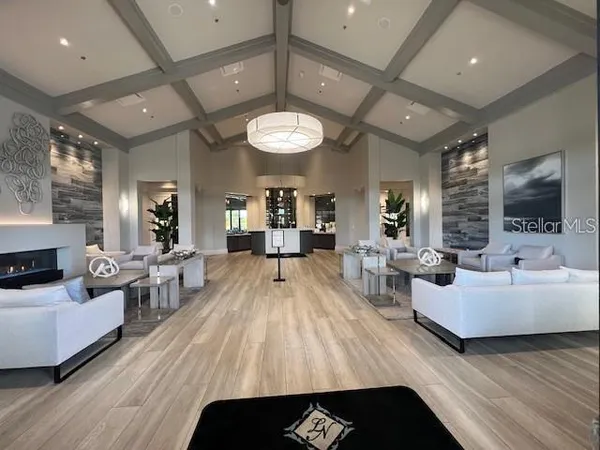 a kitchen with a dining table chairs cabinets and stainless steel appliances