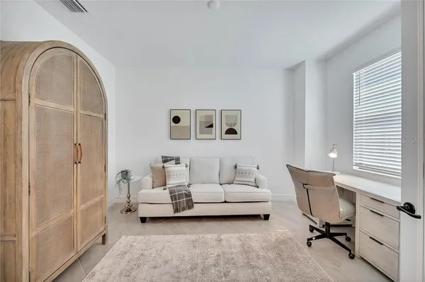 a living room with furniture a chandelier and a table