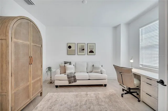 a living room with furniture a chandelier and a table