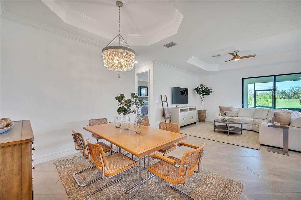 5822 Brandon Run Bradenton, FL 34211 - Photo 5 of 34 a living room with furniture a chandelier and a table