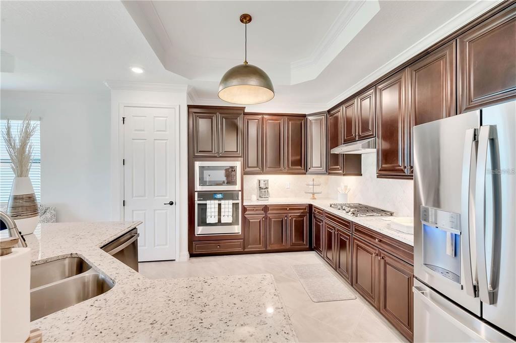 5822 Brandon Run Bradenton, FL 34211 - Photo 10 of 34 a kitchen with stainless steel appliances granite countertop a stove refrigerator and cabinets