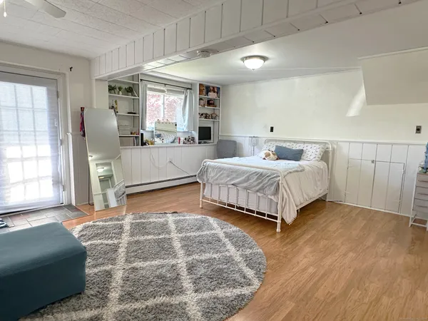 a bedroom with a large bed and a window