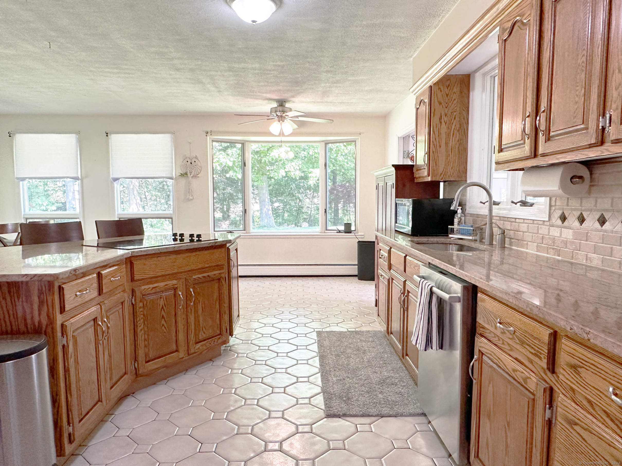 39 Mohawk Drive Norwalk, CT 06851 - Photo 11 of 37 a kitchen with granite countertop a stove sink and cabinets