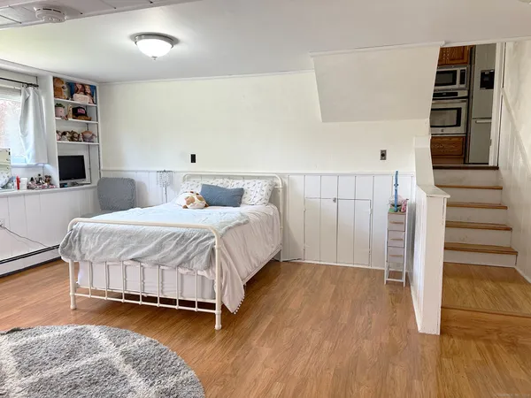 a bedroom with a bed and a book shelf