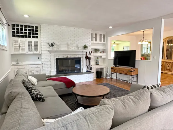 a living room with furniture fireplace and flat screen tv