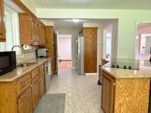 a kitchen with stainless steel appliances granite countertop a sink and a stove