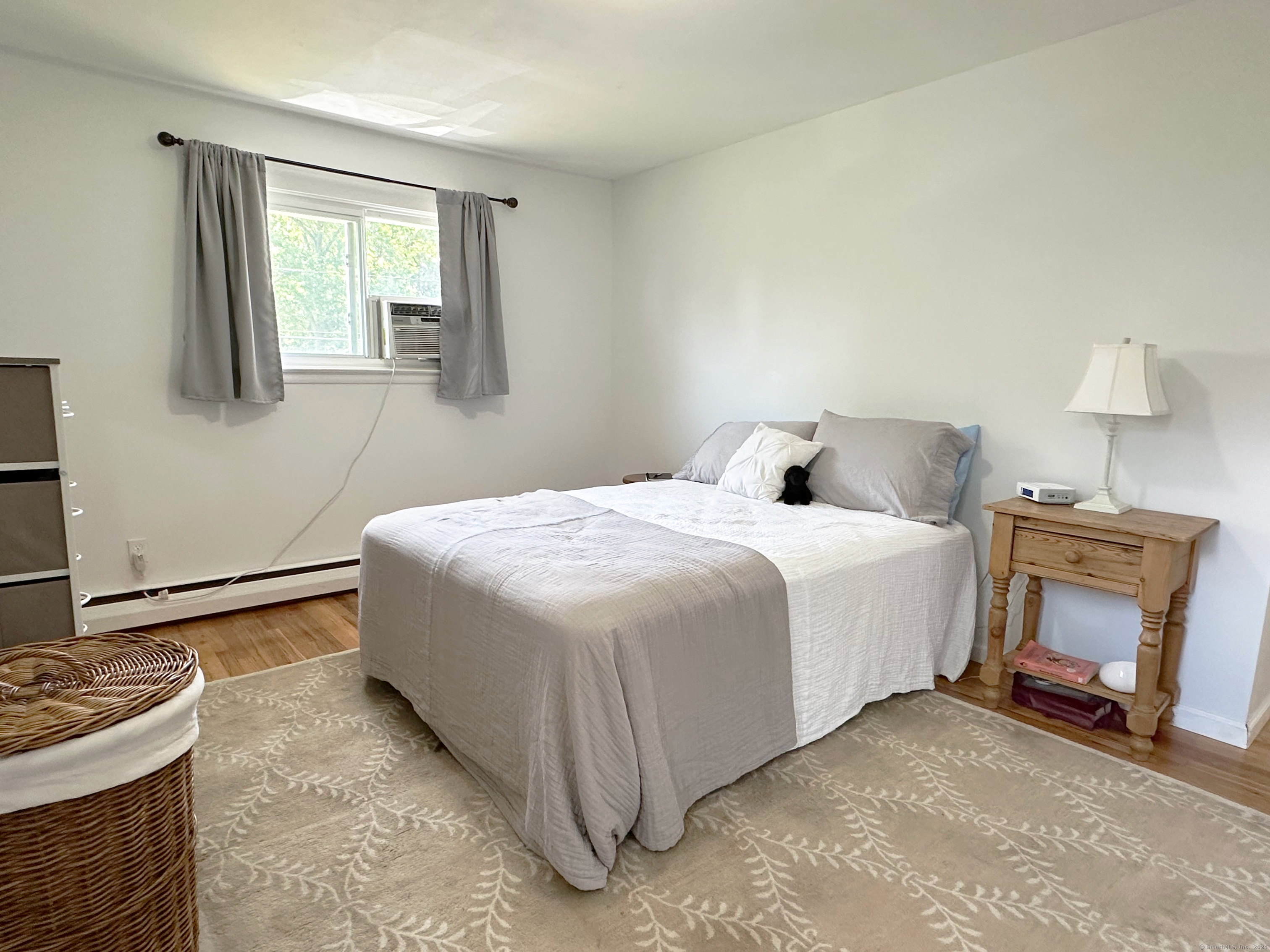 39 Mohawk Drive Norwalk, CT 06851 - Photo 21 of 37 a bedroom with a bed and a fireplace