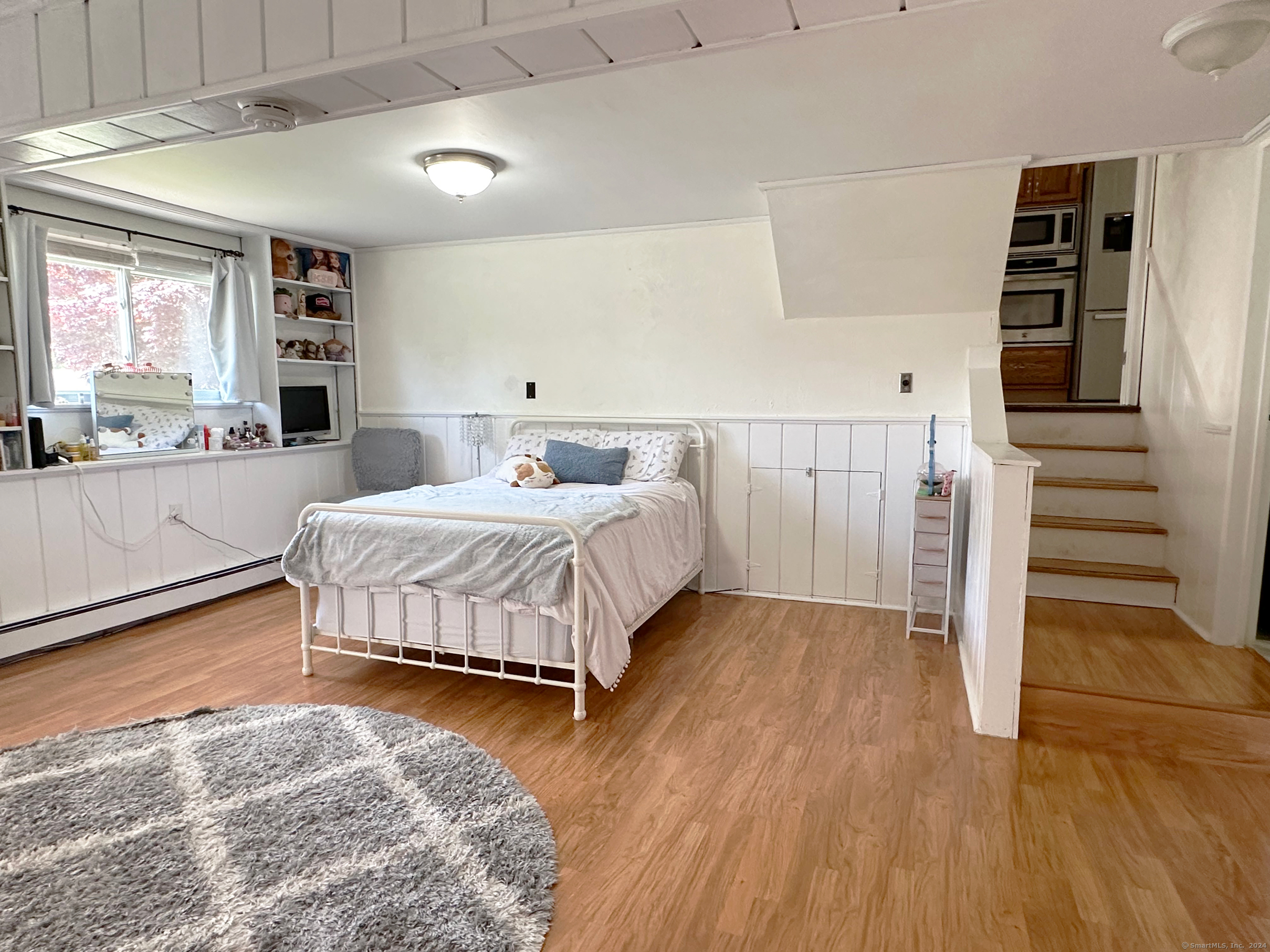 39 Mohawk Drive Norwalk, CT 06851 - Photo 29 of 37 a bedroom with a bed and a view of kitchen