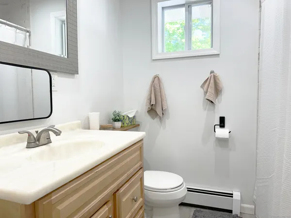 a bathroom with a sink toilet and a mirror