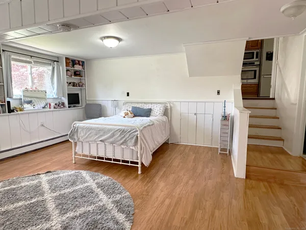 a bedroom with a bed and a view of kitchen