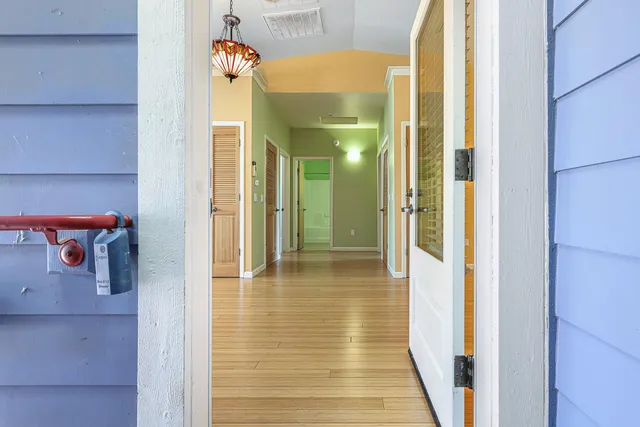 a view of a hallway with wooden shelves