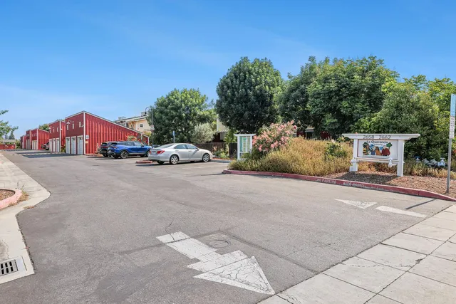 a living room with furniture a rug and a book shelf