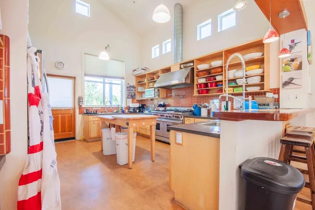 a patio with a table and chairs and potted plants