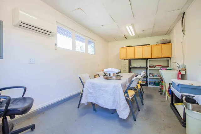 a view of a swimming pool with a patio and plants