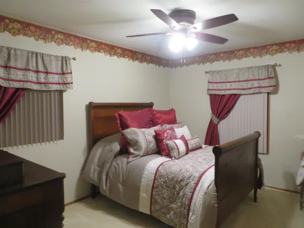 a bedroom with a bed and lamp