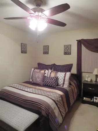 a bedroom with a bed and a mirror