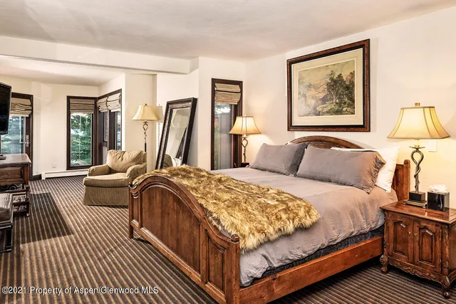 a bedroom with a bed couch and a window