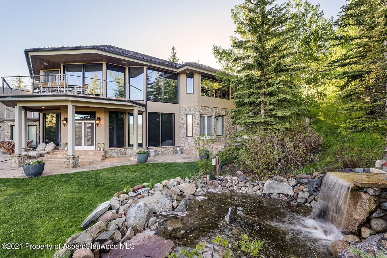 572 North Starwood Road Aspen, CO 81612 - Photo 3 of 26 a front view of a house with a yard table and chairs
