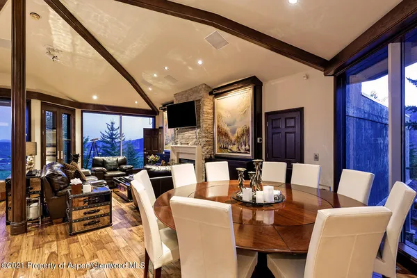 a living room with fireplace furniture and a large window