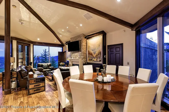 a living room with fireplace furniture and a large window