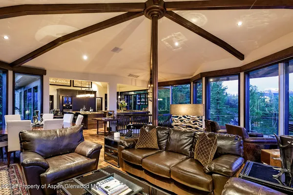 a living room with furniture fireplace and a large window